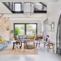 House in Brittany | Living room with mezzanine, stone wall and exposed beams | Interior Designers